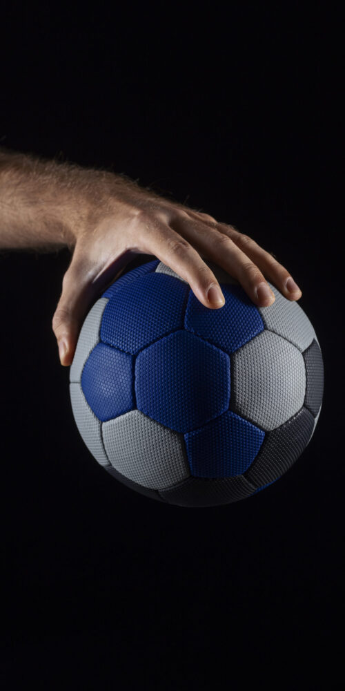 close-up-hand-holding-handball-ball